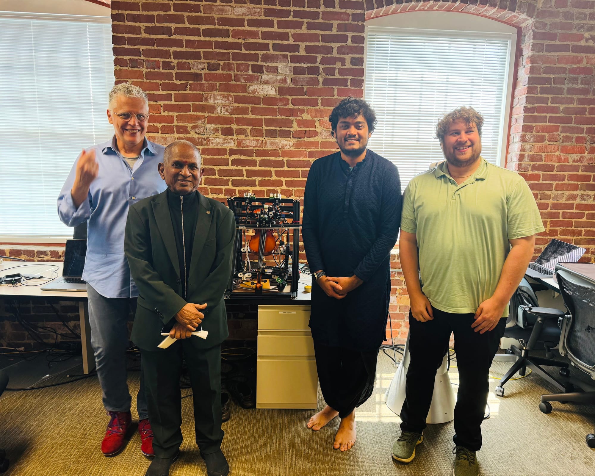 With visitors in the lab, a robot on the bench behind